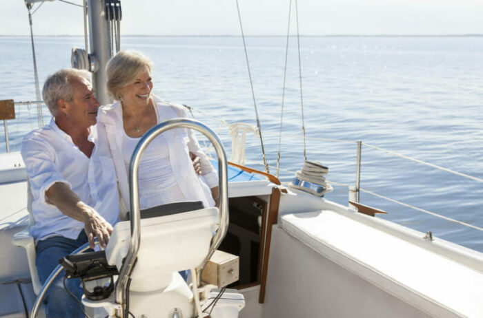 Senior couple on sailboat with a calm sea