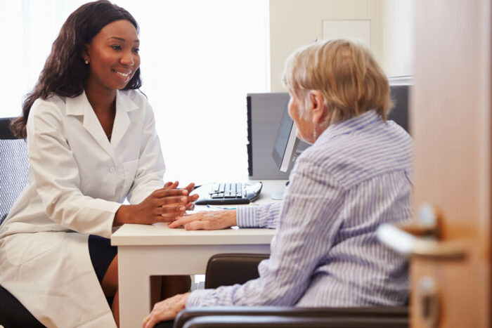 Doctor consulting with senior patient